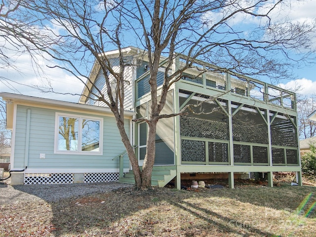 view of side of home featuring a sunroom