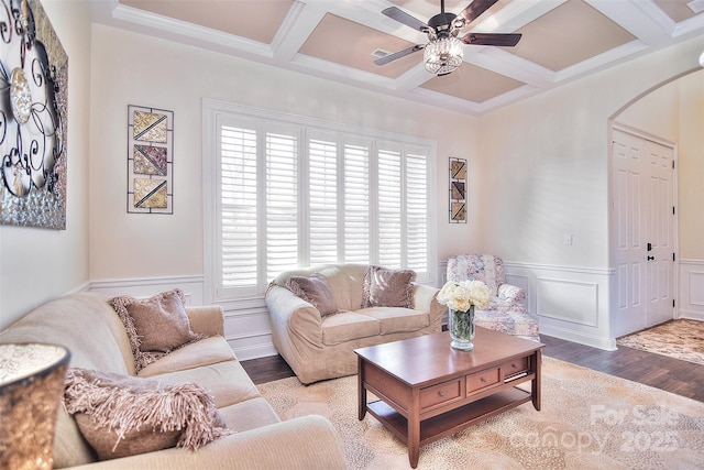 living area featuring arched walkways, beam ceiling, and wood finished floors