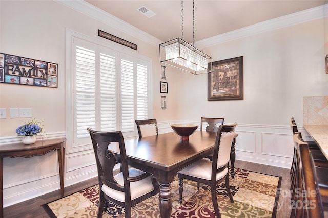 dining area featuring crown molding and dark hardwood / wood-style floors