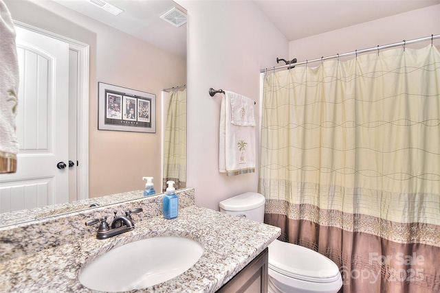 bathroom with a shower with curtain, vanity, and toilet