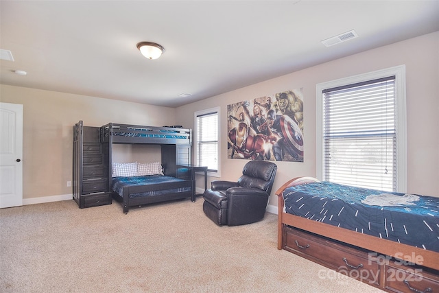 carpeted bedroom with visible vents and baseboards