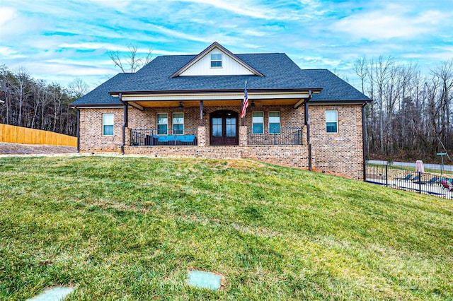 view of front of home featuring covered porch and a front lawn