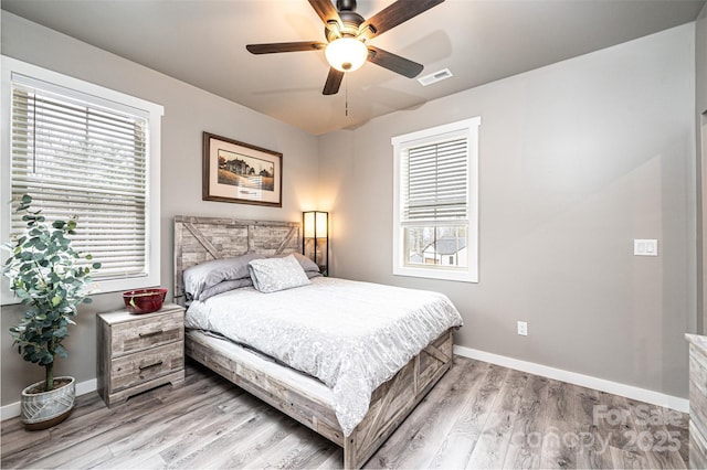 bedroom with multiple windows, ceiling fan, and light wood-type flooring