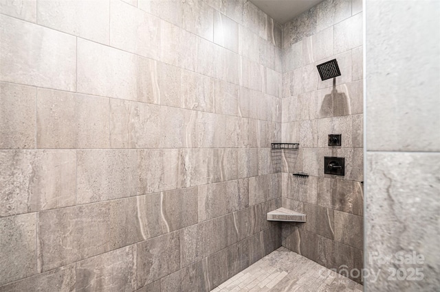 bathroom with a tile shower