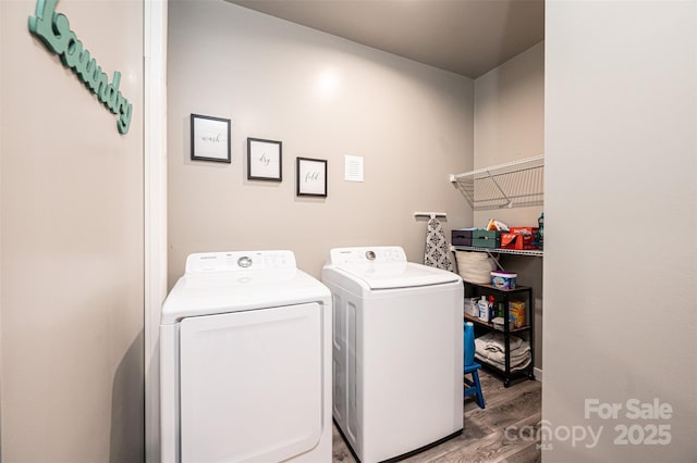 washroom featuring washer and clothes dryer and light hardwood / wood-style flooring