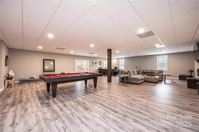 rec room featuring a drop ceiling, light hardwood / wood-style floors, and french doors