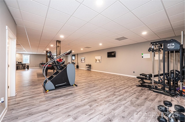 workout room featuring a drop ceiling and hardwood / wood-style flooring