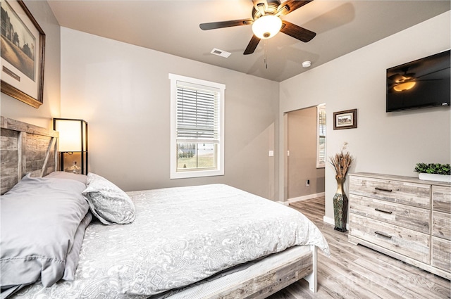 bedroom with ceiling fan and wood-type flooring