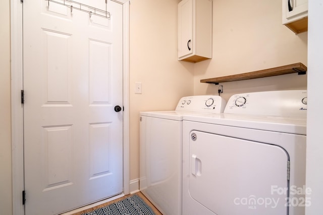 laundry area featuring cabinets and separate washer and dryer