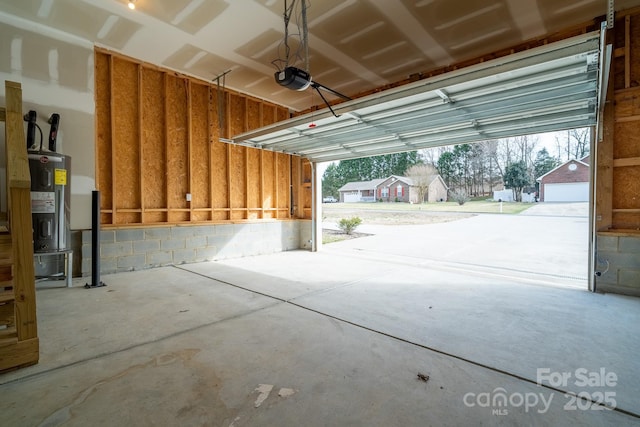 garage with water heater and a garage door opener