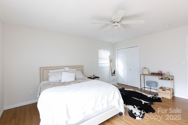 bedroom featuring dark hardwood / wood-style floors, a closet, and ceiling fan