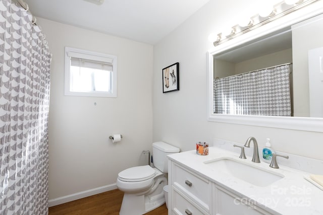 bathroom with vanity, hardwood / wood-style flooring, toilet, and walk in shower