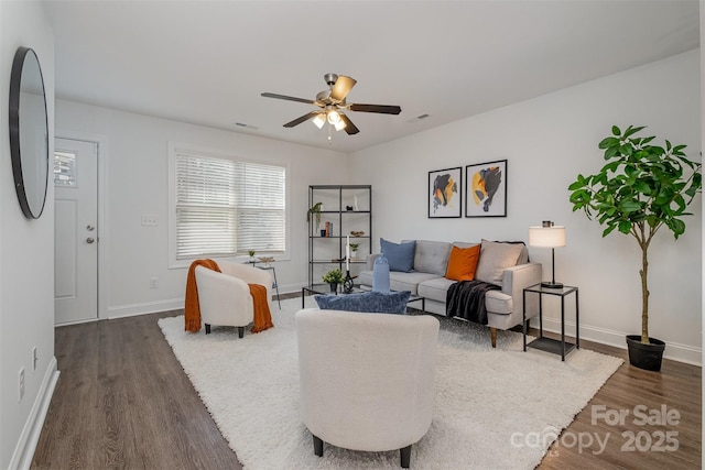 living room featuring dark hardwood / wood-style floors and ceiling fan