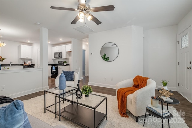 living room with hardwood / wood-style flooring and ceiling fan