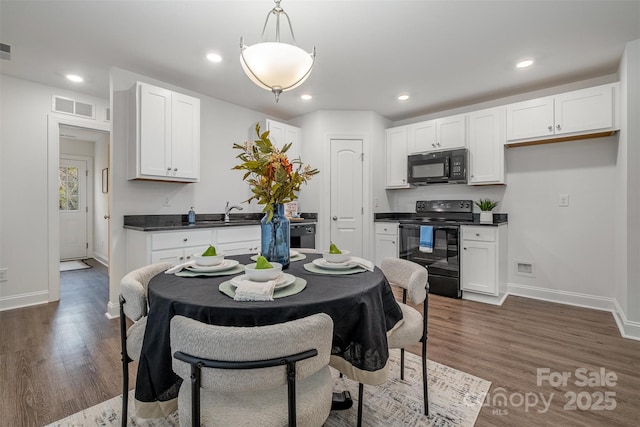 dining area with dark hardwood / wood-style flooring and sink