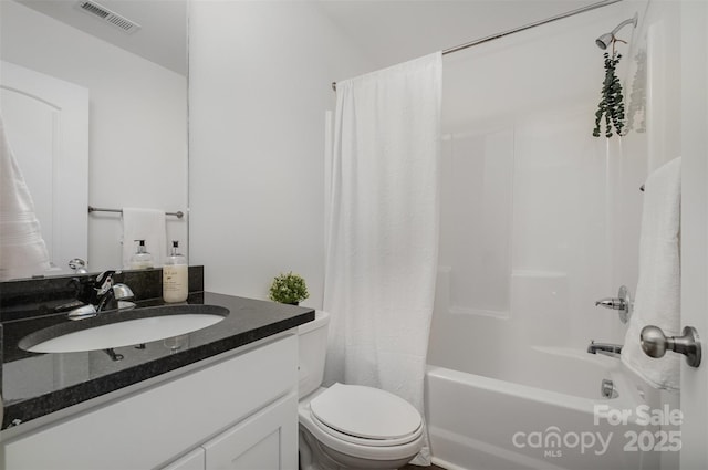 full bathroom with vanity, shower / bath combination with curtain, and toilet