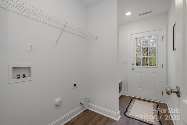 washroom featuring dark wood-type flooring, hookup for an electric dryer, hookup for a gas dryer, and hookup for a washing machine