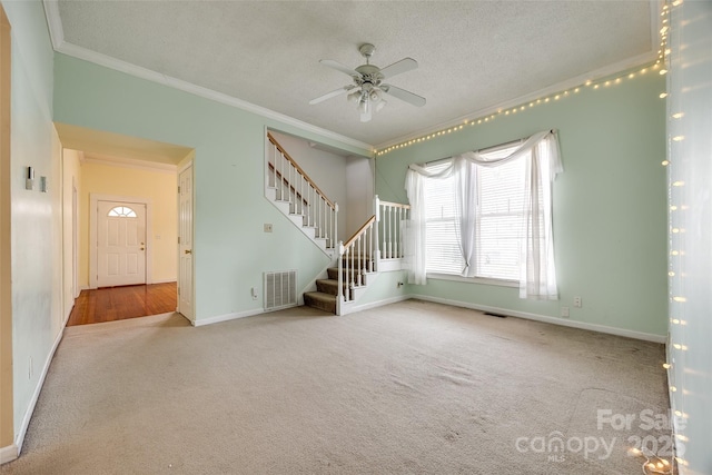 unfurnished living room with crown molding, carpet, and a textured ceiling