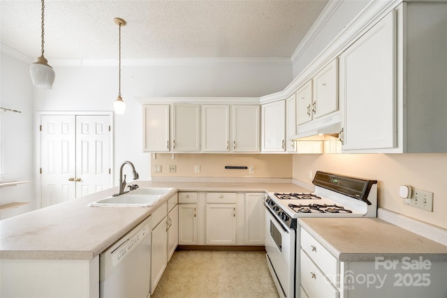 kitchen with sink, white appliances, decorative light fixtures, and white cabinets