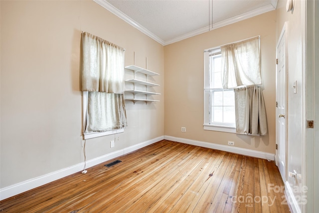 unfurnished room with ornamental molding and light hardwood / wood-style floors