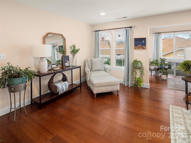 living area with a healthy amount of sunlight and dark wood-type flooring