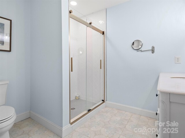 bathroom with vanity, an enclosed shower, and toilet