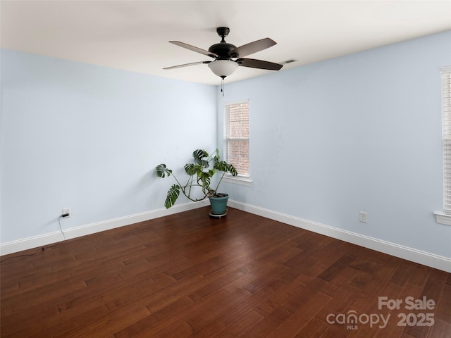 empty room featuring dark hardwood / wood-style floors and ceiling fan