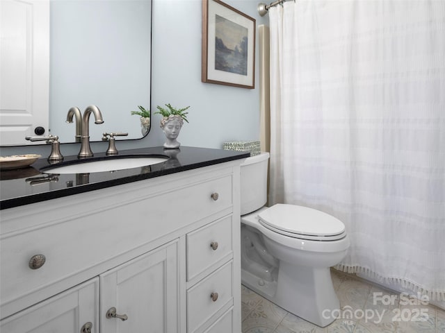 bathroom with vanity, tile patterned flooring, and toilet