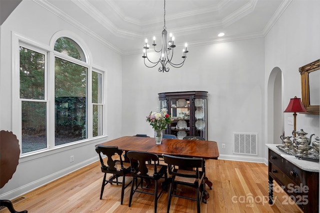 dining room with ornamental molding, a tray ceiling, and a wealth of natural light