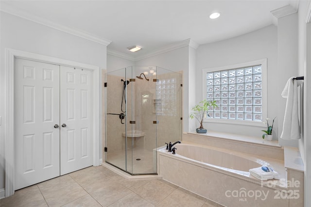 bathroom featuring crown molding, independent shower and bath, and tile patterned flooring