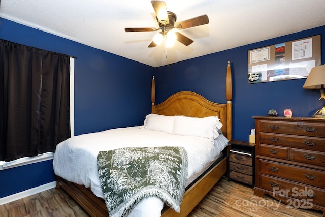 bedroom with hardwood / wood-style flooring and ceiling fan