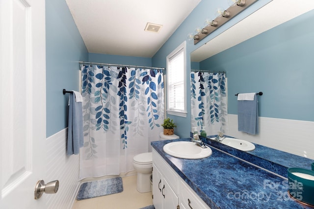 full bath with curtained shower, visible vents, toilet, vanity, and tile patterned floors