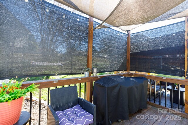 wooden deck featuring grilling area