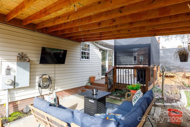 view of patio with a wooden deck and an outdoor hangout area