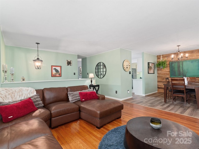 living room with hardwood / wood-style floors and a notable chandelier