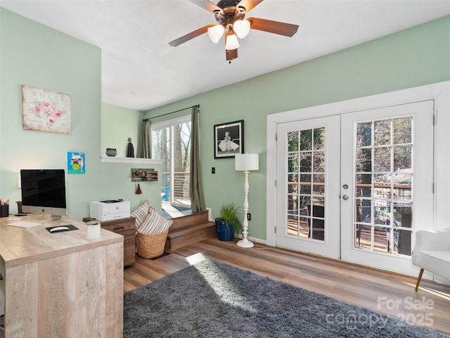 interior space featuring wood-type flooring, ceiling fan, and french doors