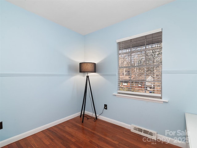 empty room featuring dark hardwood / wood-style flooring