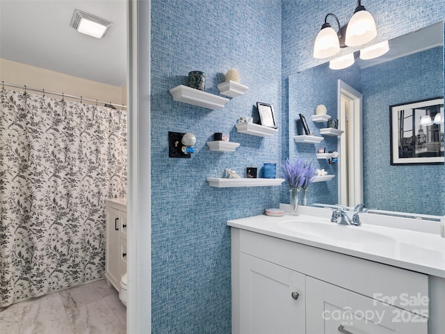 bathroom with vanity and a notable chandelier