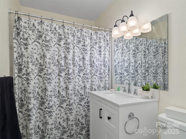 bathroom featuring vanity, curtained shower, an inviting chandelier, and toilet