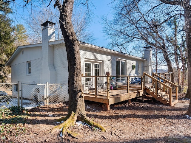 rear view of house featuring a wooden deck