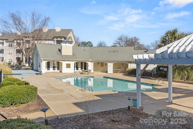 view of swimming pool featuring a patio and a pergola