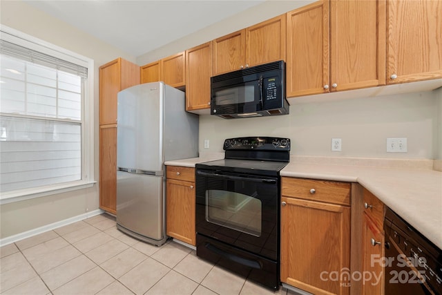 kitchen featuring light tile patterned floors and black appliances