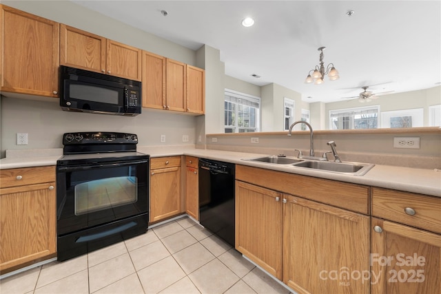 kitchen featuring black appliances, decorative light fixtures, light tile patterned flooring, a chandelier, and sink