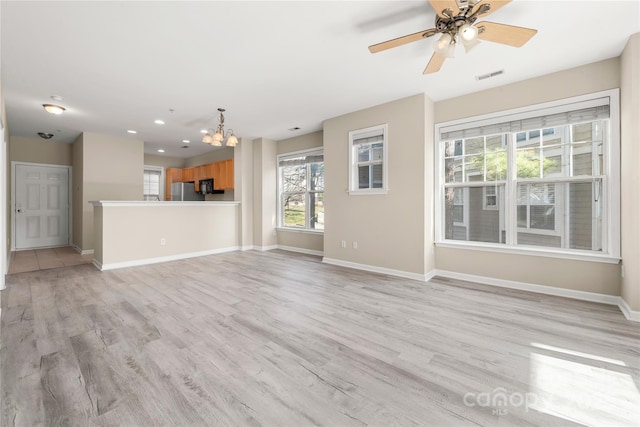 unfurnished living room with light hardwood / wood-style flooring and ceiling fan