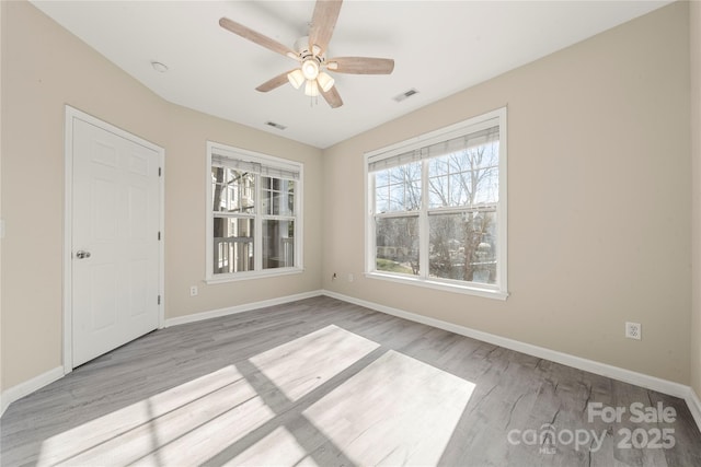 empty room featuring ceiling fan and light hardwood / wood-style flooring