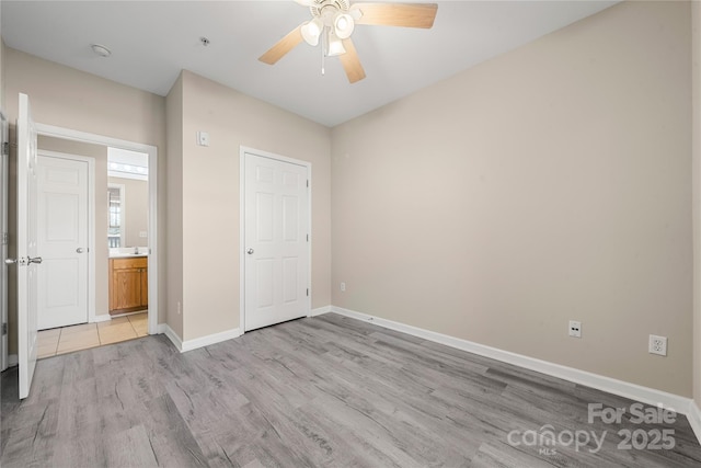 unfurnished bedroom featuring ceiling fan and light wood-type flooring