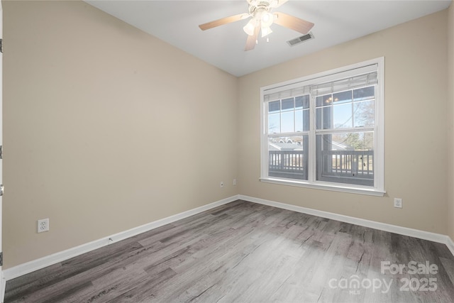 spare room featuring hardwood / wood-style floors and ceiling fan