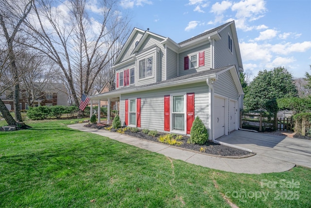 view of front of home with concrete driveway, a front lawn, and an attached garage