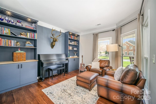 living area featuring dark wood-style floors and crown molding