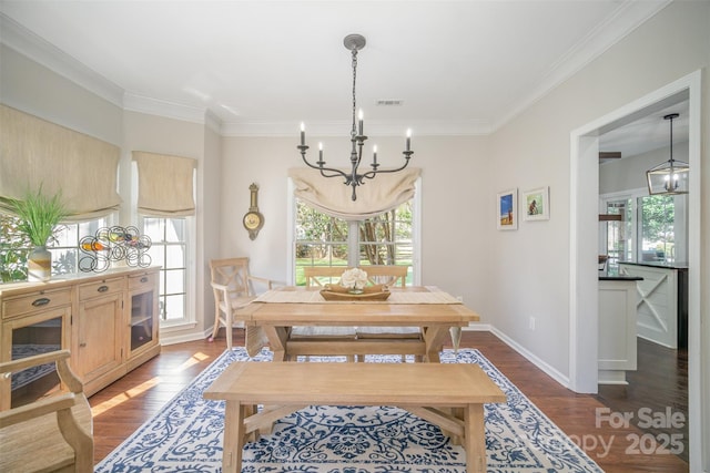 dining space featuring a notable chandelier, visible vents, baseboards, dark wood finished floors, and crown molding